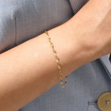 Model wearing a 14k gold textured chain bracelet, elegant with shimmering starburst accents.