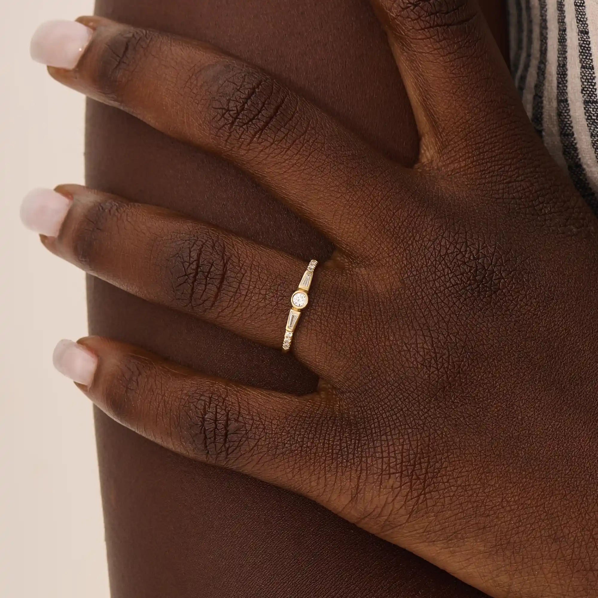 Model wearing a 14k solid gold bezel mixed cut promise ring, showcasing its sparkling moissanite stones and modern, elegant style.