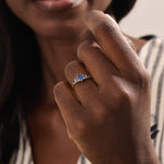 Model wearing a 5 pear sapphire gold ring on hand. Classic anniversary ring with vivid blue sapphires in 14k solid gold.