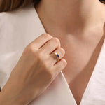 Model wearing a Toi et Moi sapphire and moissanite engagement ring. Unique gold ring symbolizing two souls, one love.