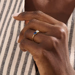 Model wearing a Toi et Moi sapphire and moissanite engagement ring. Unique gold ring symbolizing two souls, one love.