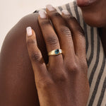 Model wearing a bold Toi et Moi ring with pear topaz and oval moissanite on a thick gold dome band.