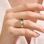 Model wearing a bold Toi et Moi ring with pear topaz and oval moissanite on a thick gold dome band.