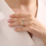 Model wearing a chunky 14k gold ring with half bezel set oval topaz. A statement gemstone ring with modern lines. Ideal for daily elegance or gifting.