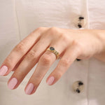 Model wearing a chunky 14k gold ring with half bezel set oval topaz. A statement gemstone ring with modern lines. Ideal for daily elegance or gifting.