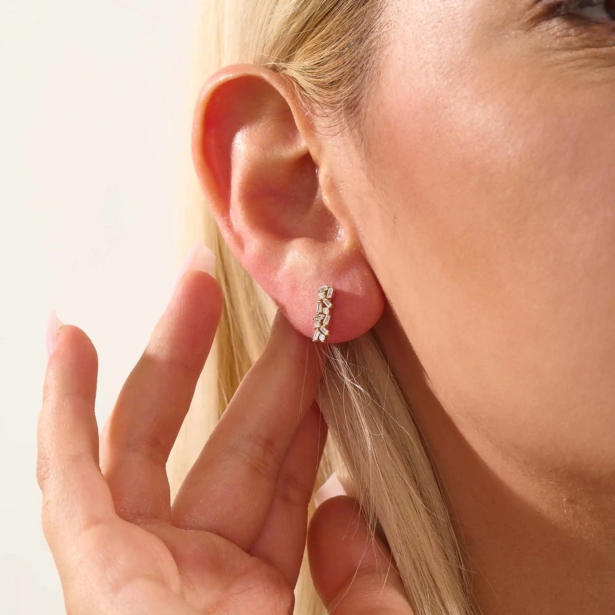 Model wearing baguette cluster stud earrings in 14k gold, showing their sparkling and contemporary clustered silhouette.