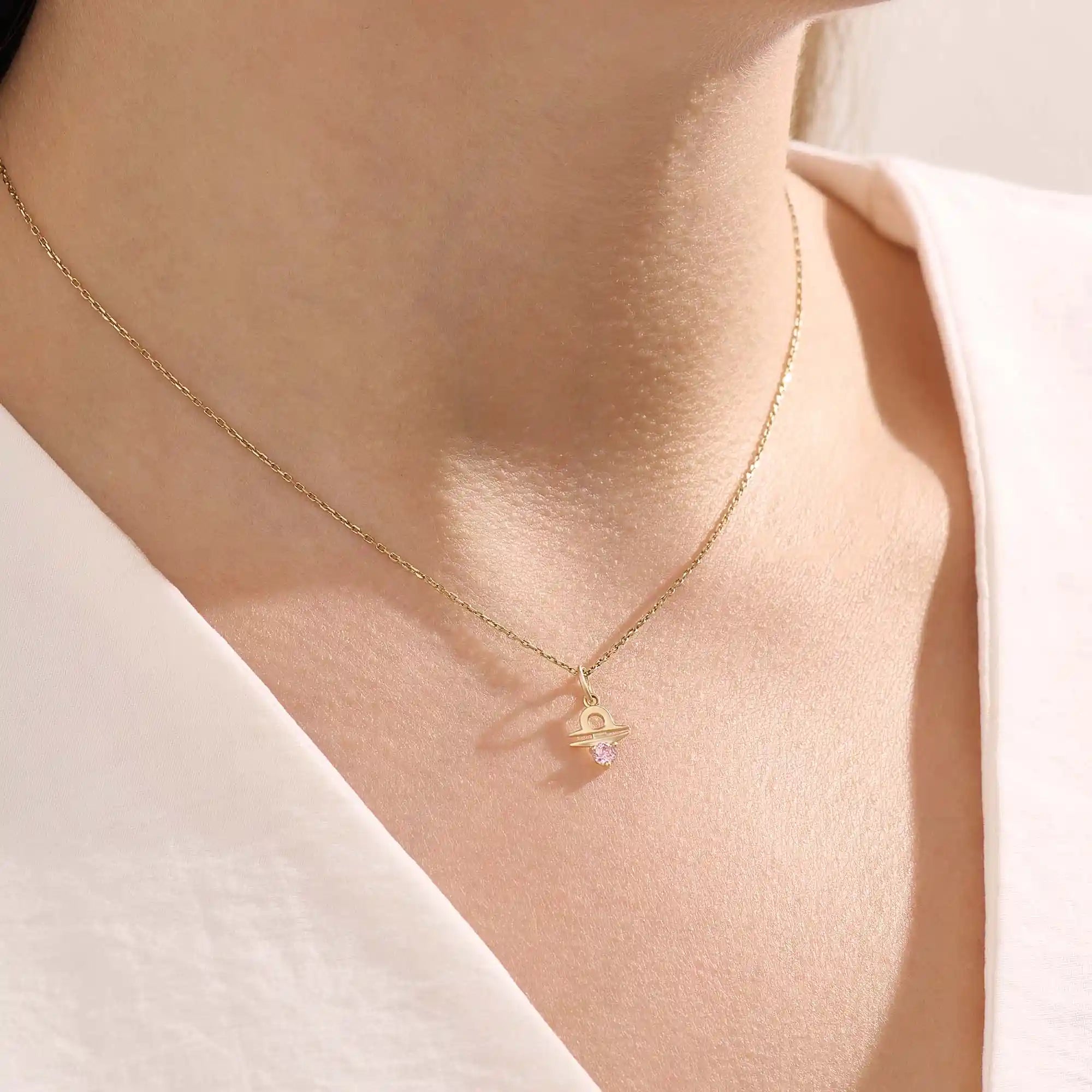 Model wears a 14k gold Libra zodiac pendant necklace featuring pink tourmaline. Perfect for Libra zodiac birthdays and gifts.
