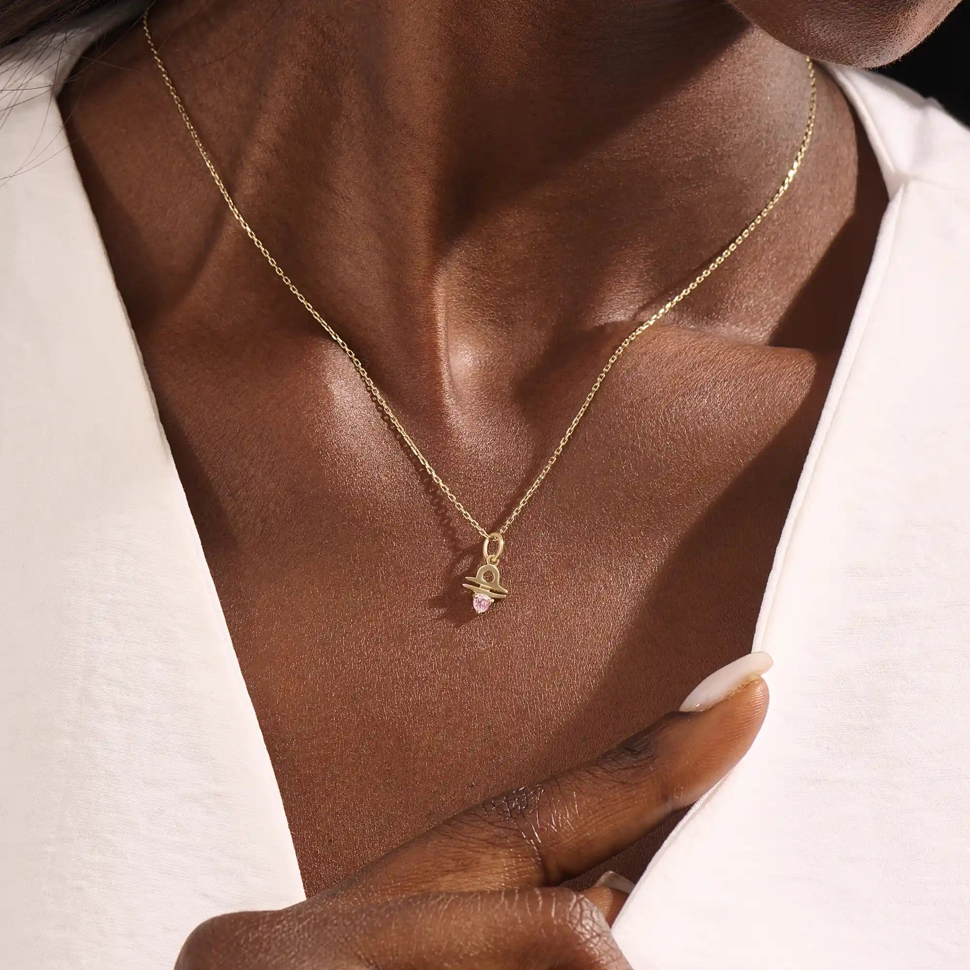 Model wears a 14k gold Libra zodiac pendant necklace featuring pink tourmaline. Perfect for Libra zodiac birthdays and gifts.