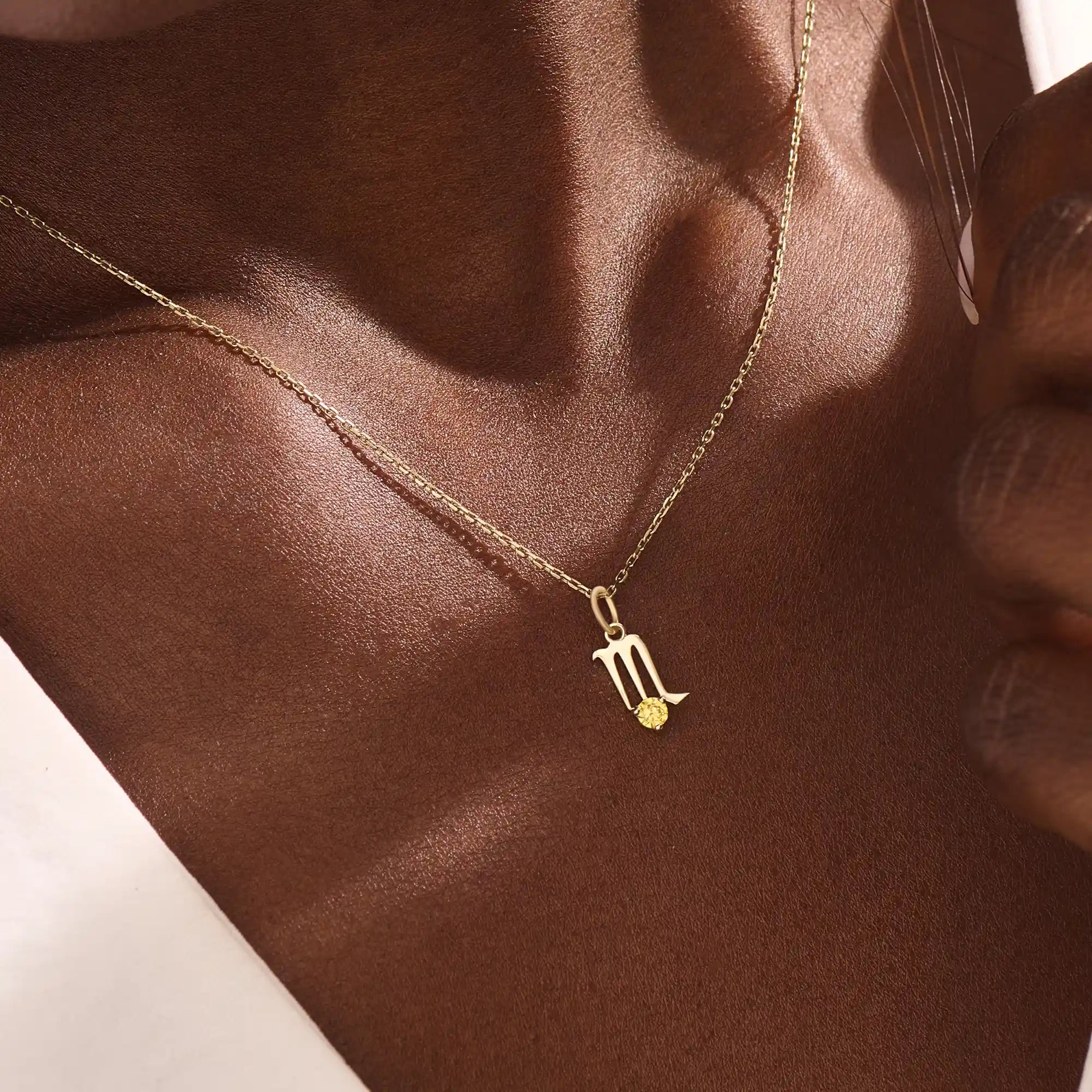 Model wears a 14k gold Scorpio zodiac pendant necklace featuring a citrine stone. Perfect gift for Scorpio zodiac birthdays.