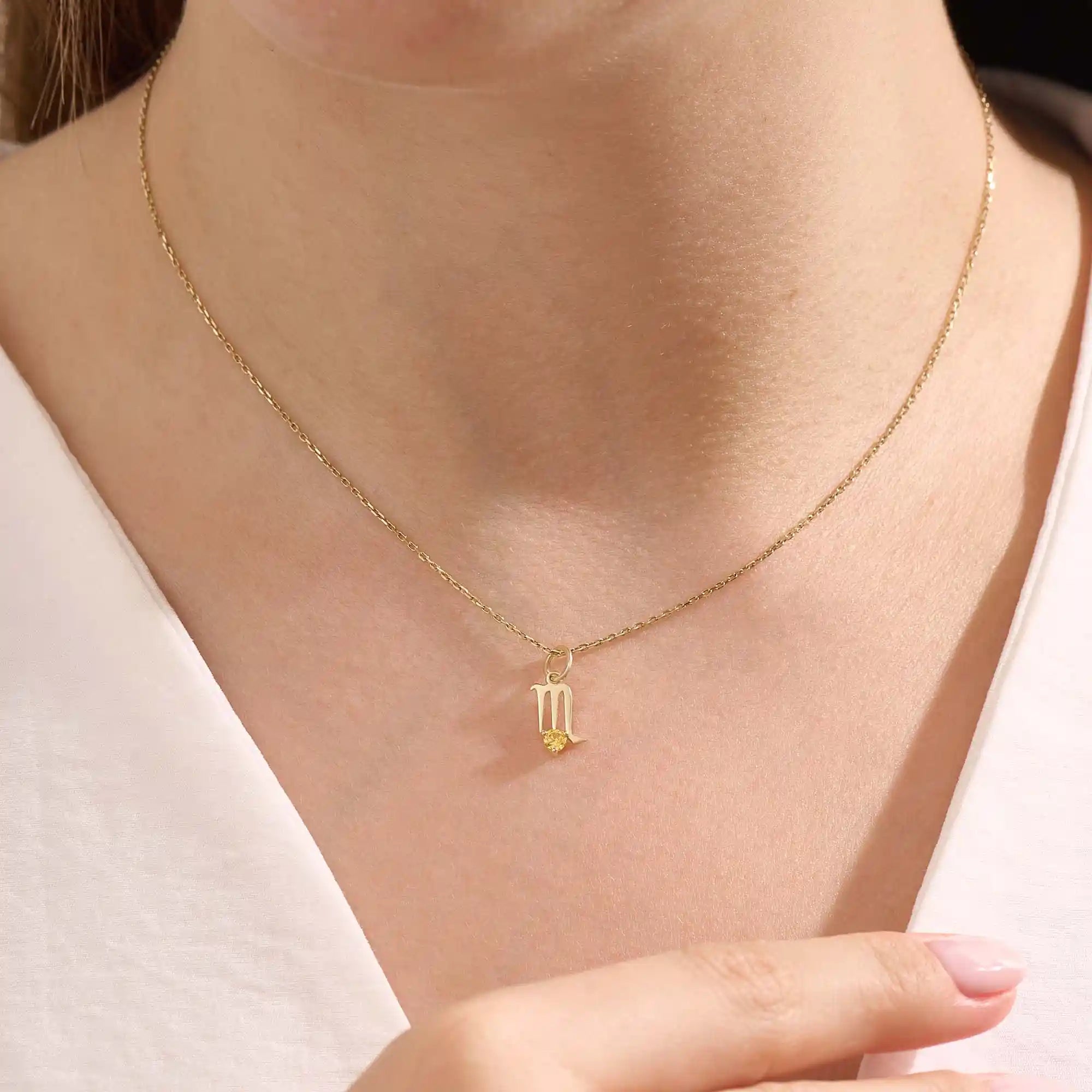 Model wears a 14k gold Scorpio zodiac pendant necklace featuring a citrine stone. Perfect gift for Scorpio zodiac birthdays.