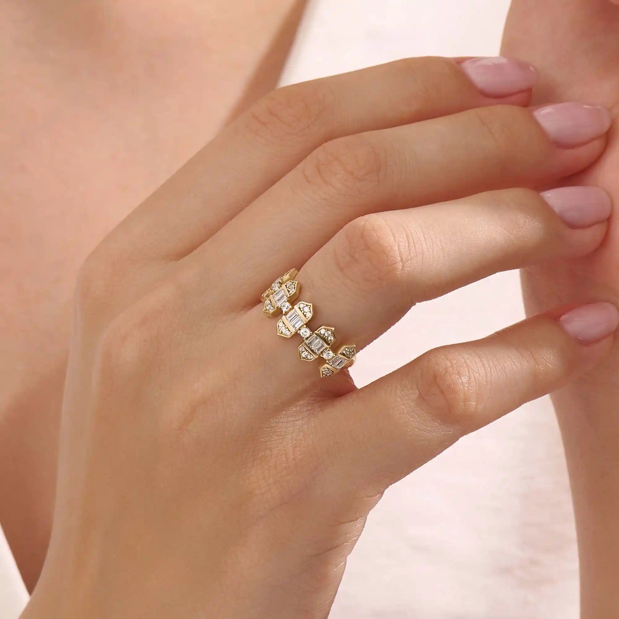 Model wears a 14k gold bold baguette spike statement ring. A distinctive and edgy accessory perfect for modern women.