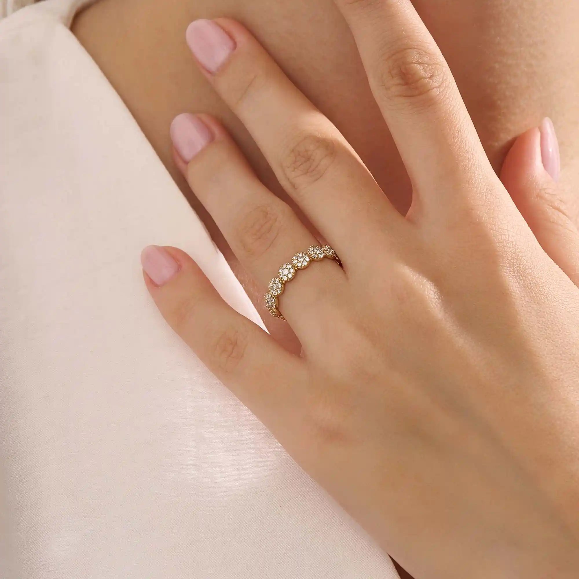 Model wears a 14k gold bold dots band ring with pave moissanites. Eye-catching statement piece for everyday style.