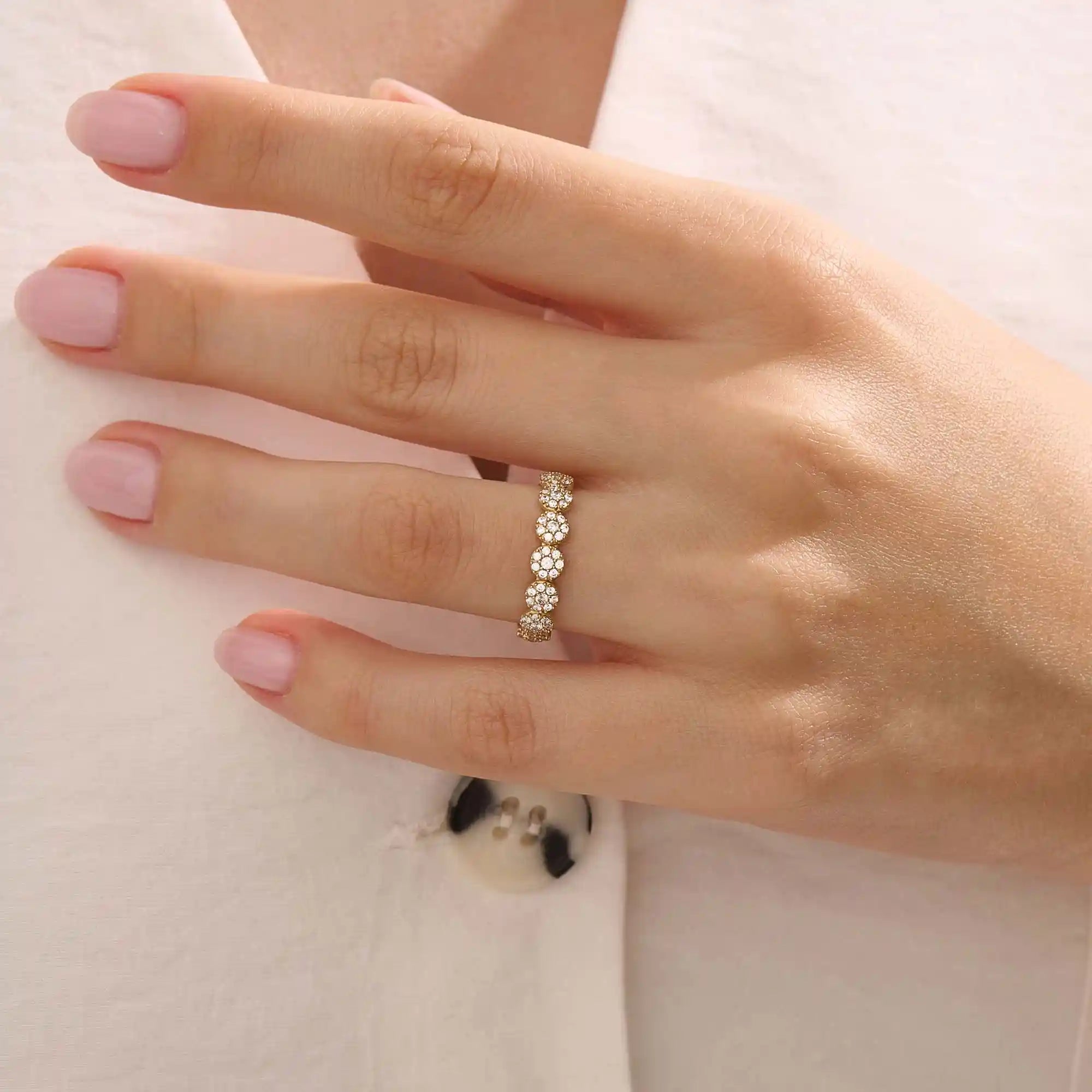 Model wears a 14k gold bold dots band ring with pave moissanites. Eye-catching statement piece for everyday style.