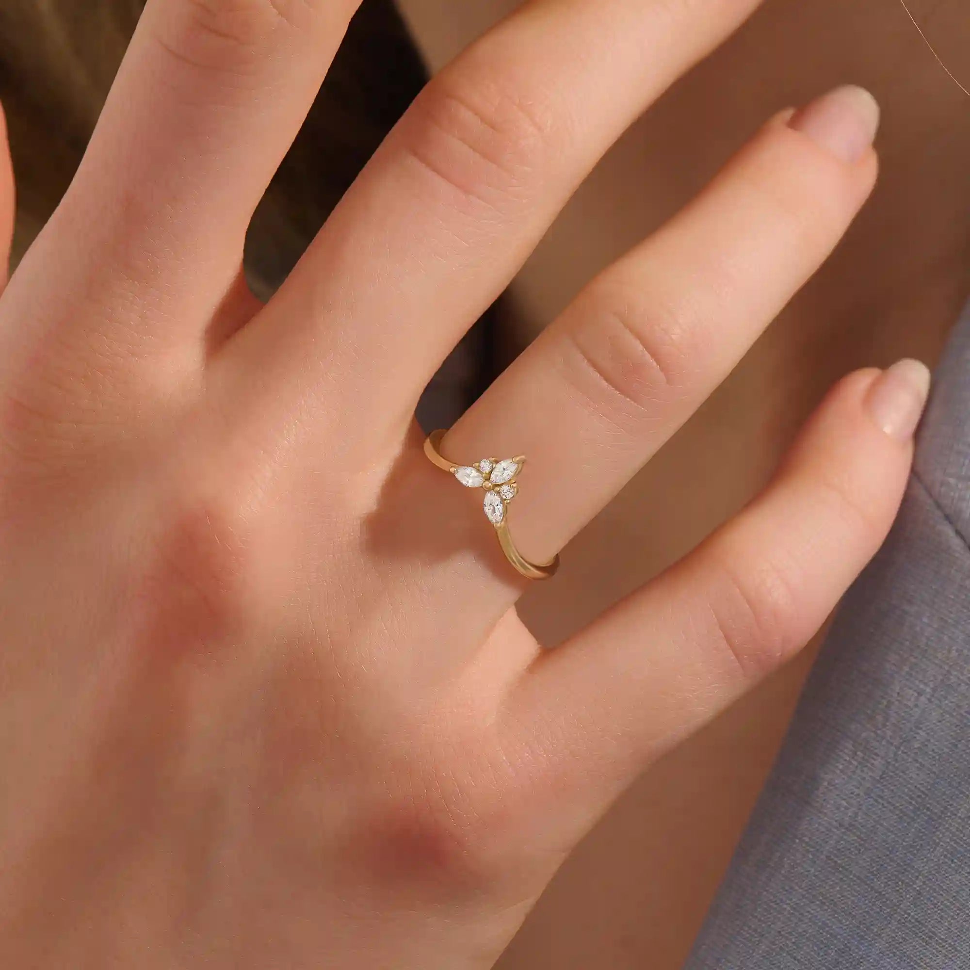 Model wears a 14k gold chevron curve nesting ring with marquise moissanites. Perfect for stacking or as a subtle statement piece.