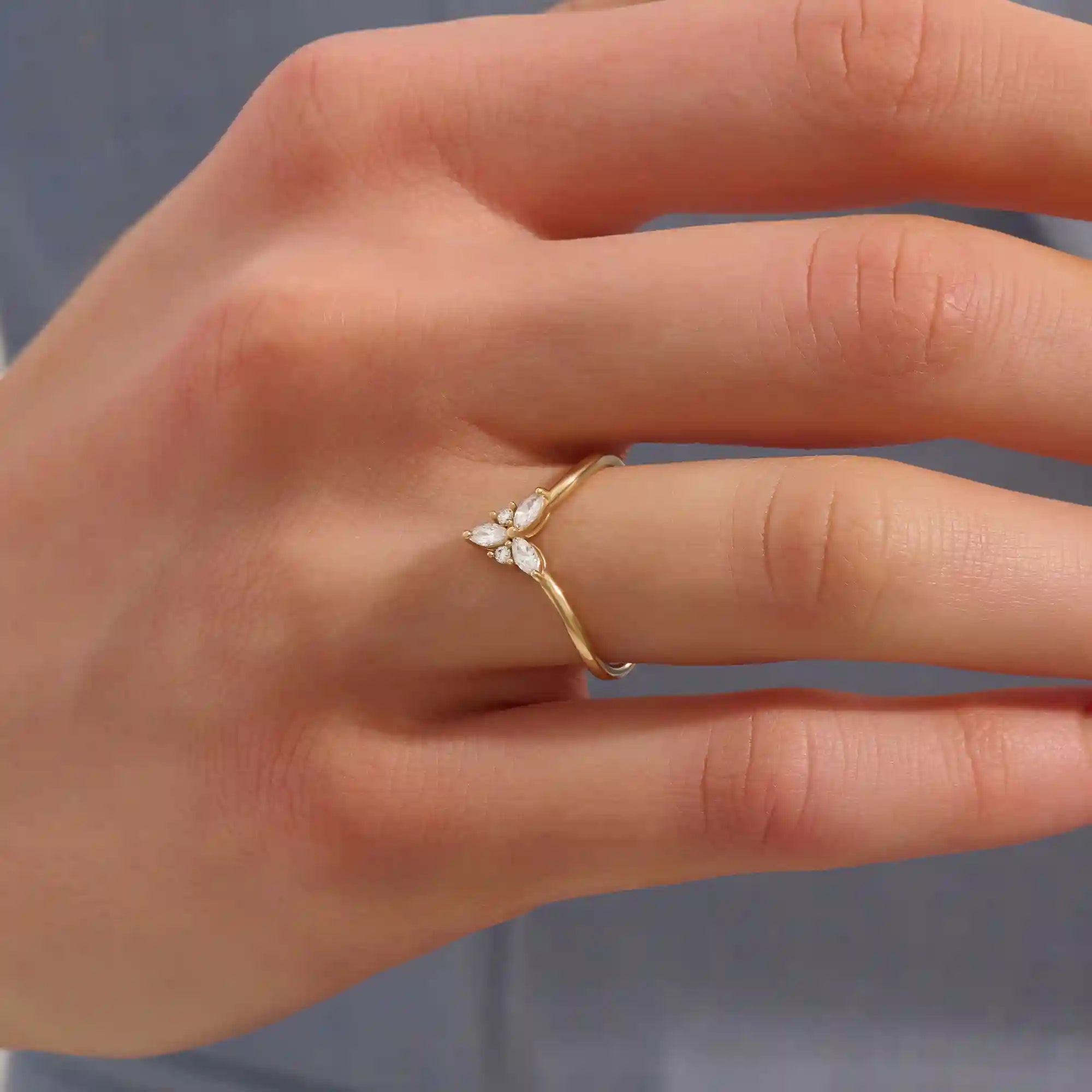 Model wears a 14k gold chevron curve nesting ring with marquise moissanites. Perfect for stacking or as a subtle statement piece.