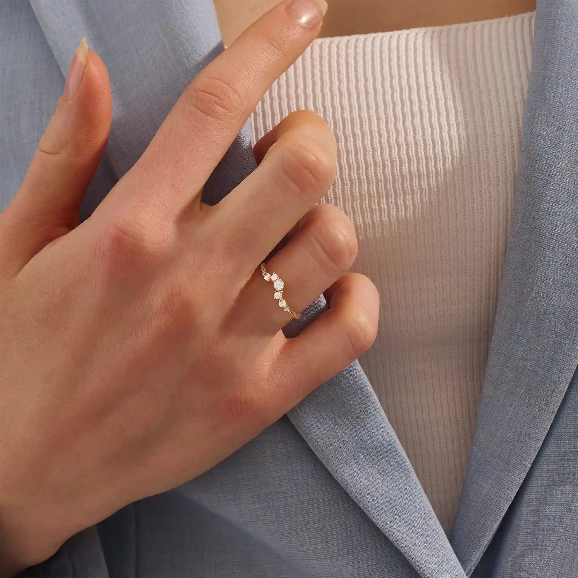 Model wears a 14k gold curved nesting ring adorned with clustered moissanites. Perfect for layering or wearing alone for subtle sparkle.