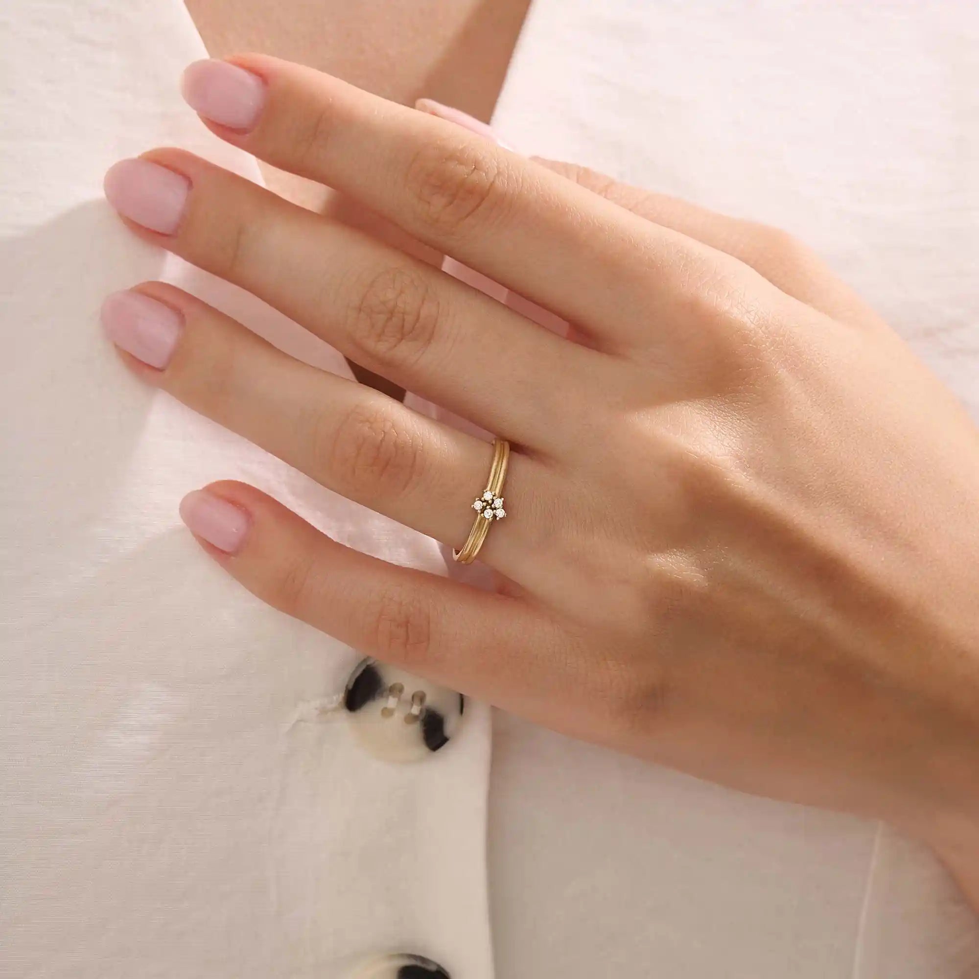 Model wears a 14k gold double band promise ring adorned with sparkling moissanites. A statement piece symbolizing commitment and style.