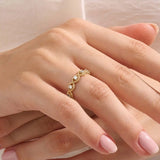 Model wears a 14k gold eternity statement ring featuring a beaded band and evil eye design. Stylish and meaningful everyday accessory.