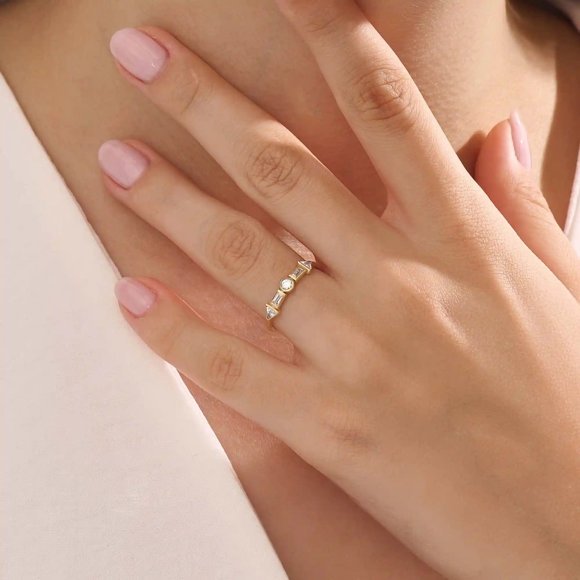 Model wears a 14k gold half eternity statement ring with bezel-set mixed cut stones. A bold and stylish piece for everyday wear.