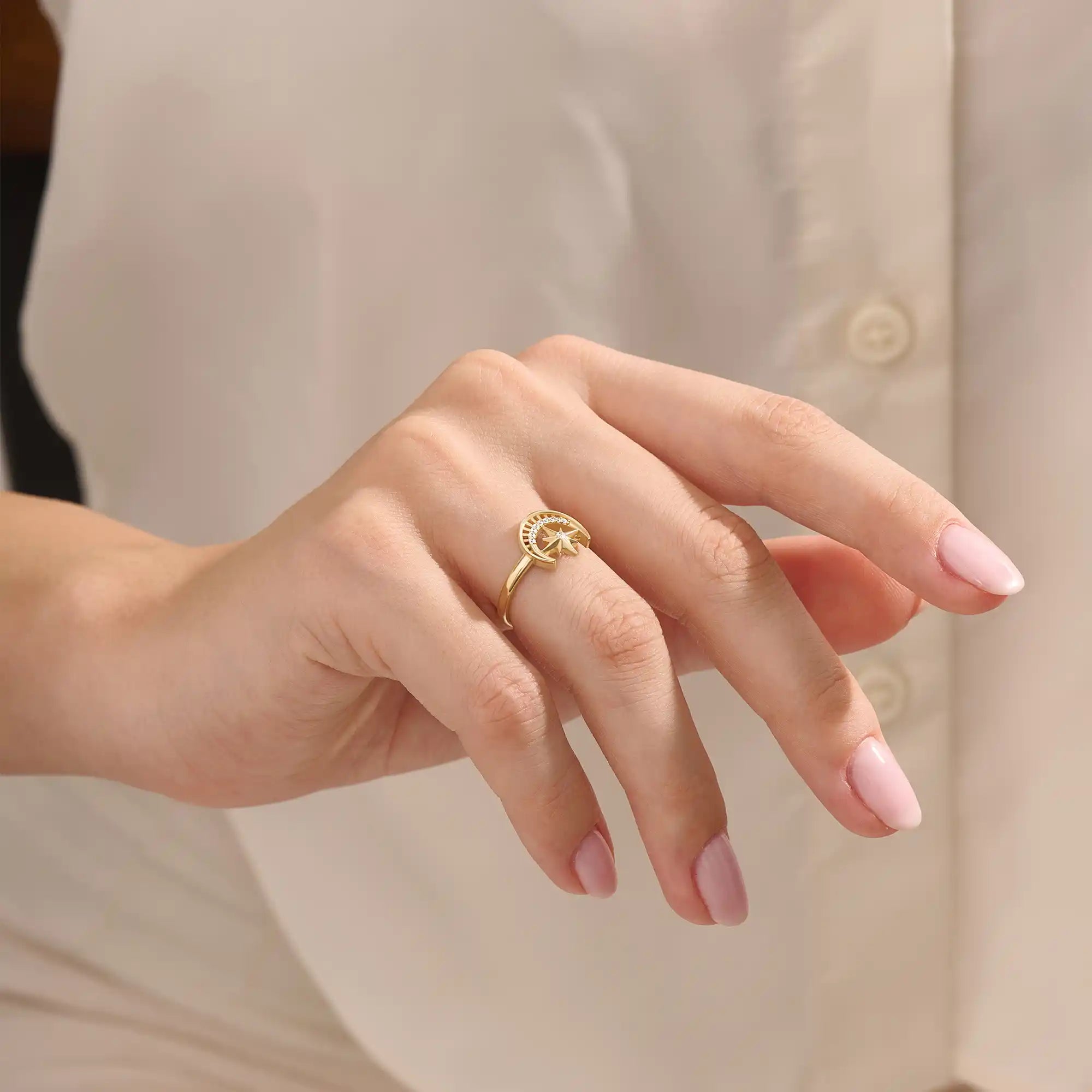 Model wears a 14k gold pinky signet ring adorned with moon and star engravings. A distinctive and stylish accessory for everyday wear.
