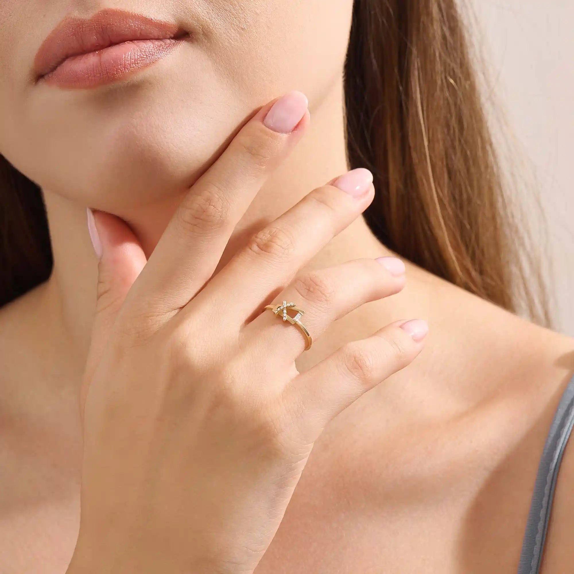 Model wears a 14k gold pinky signet ring featuring pavé moissanites in a geometric pattern. Stylish and distinctive jewelry for everyday wear.