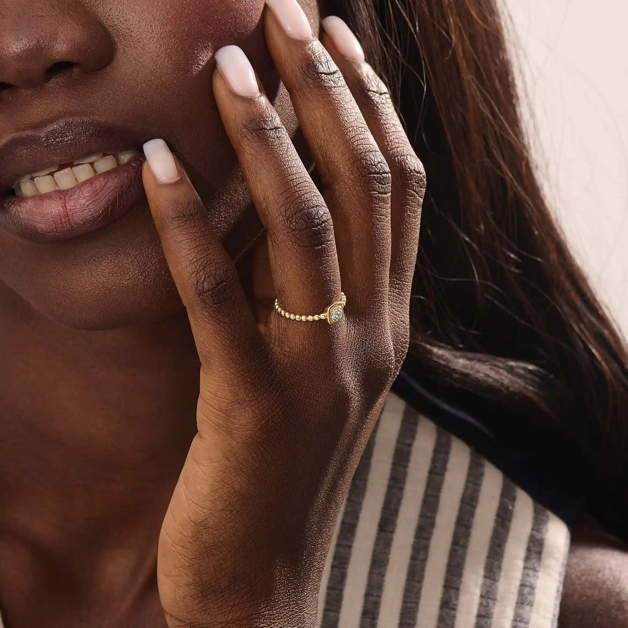 Model wears a 14k gold square pinky signet ring featuring a detailed beaded band. A sleek accessory perfect for layering or solo wear.