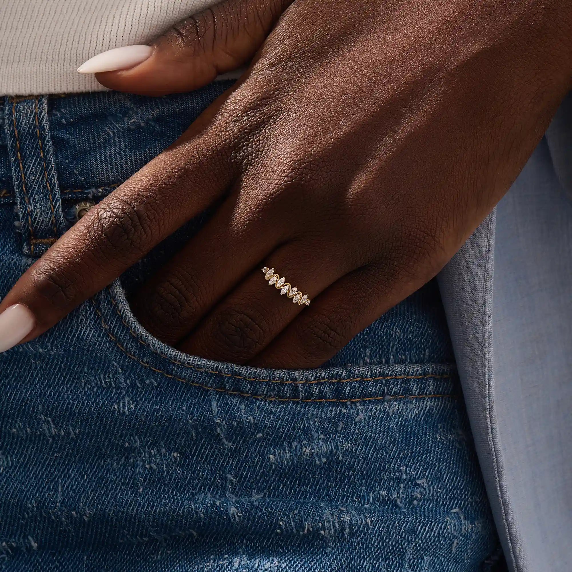 Model wears a 14k gold stacking ring featuring pavé marquise stones in an alternating ups and downs pattern. Perfect for layering with other rings.