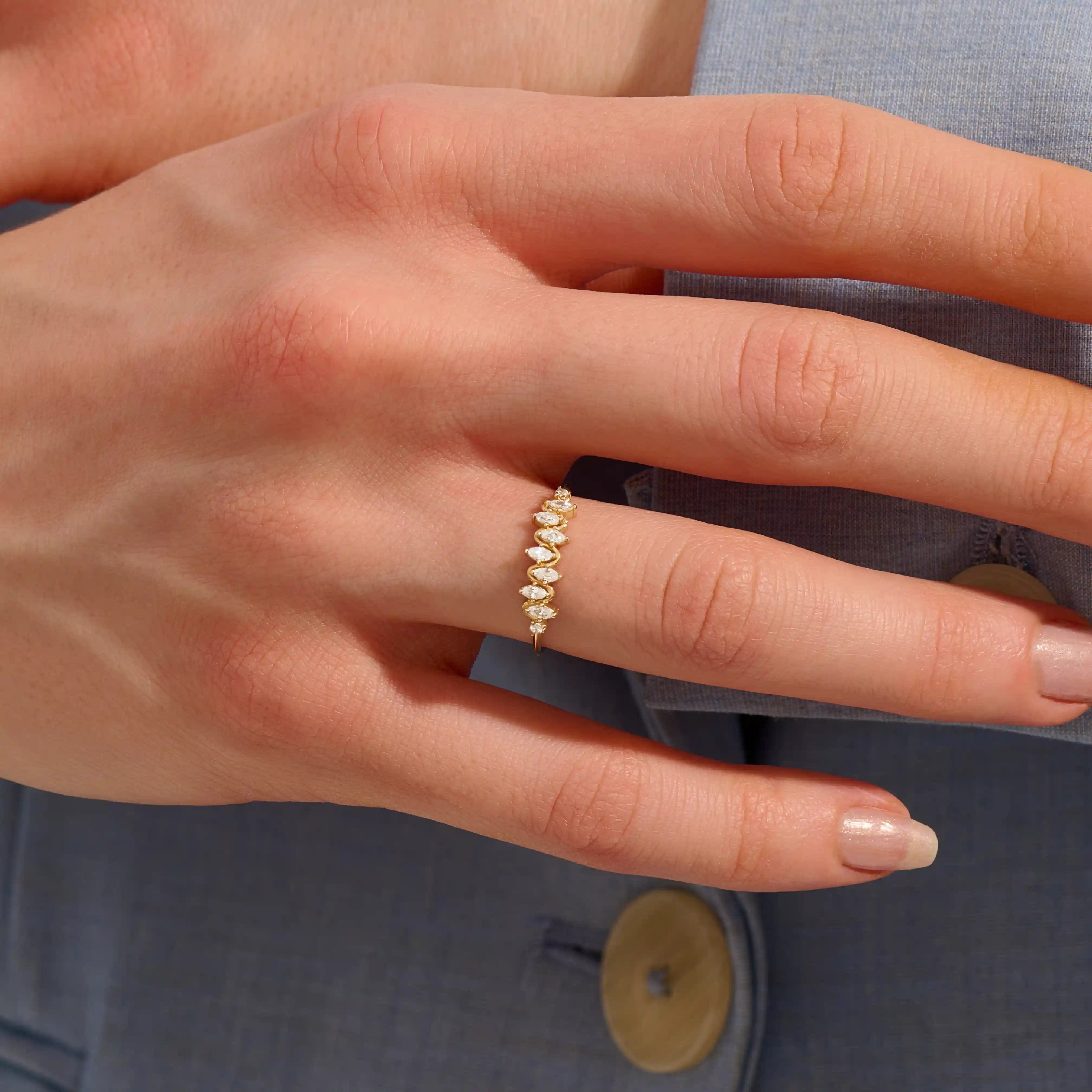 Model wears a 14k gold stacking ring featuring pavé marquise stones in an alternating ups and downs pattern. Perfect for layering with other rings.