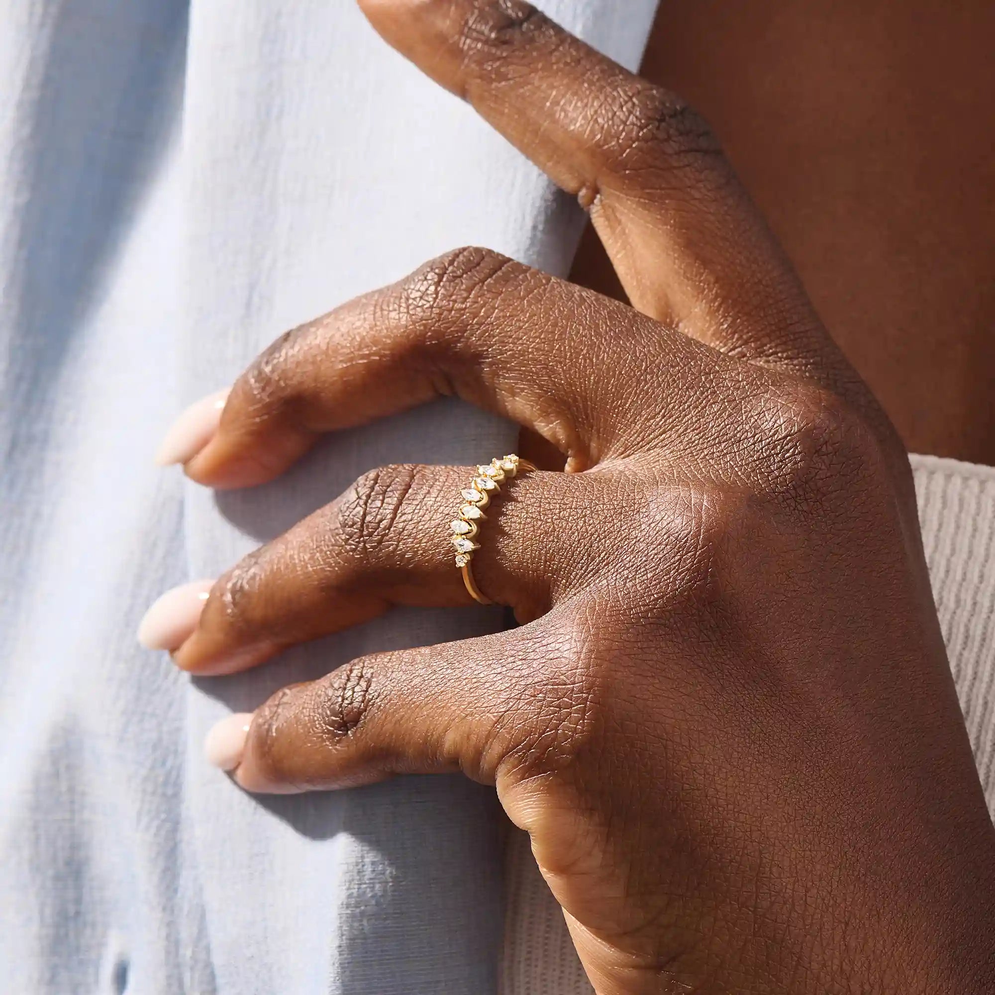Model wears a 14k gold stacking ring featuring pavé marquise stones in an alternating ups and downs pattern. Perfect for layering with other rings.