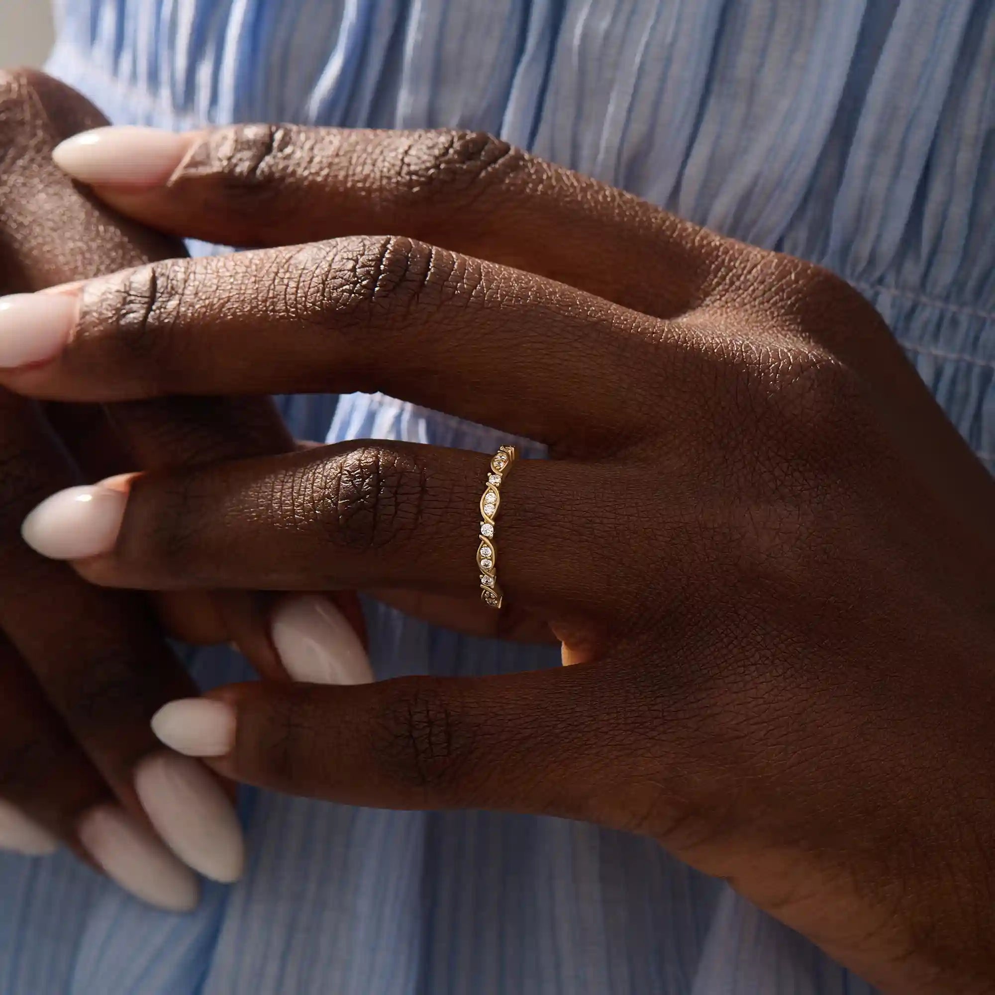 Model wears a 14k solid gold Art Deco-style stacking wedding ring featuring pave moissanites. Stylish and timeless design for modern brides.