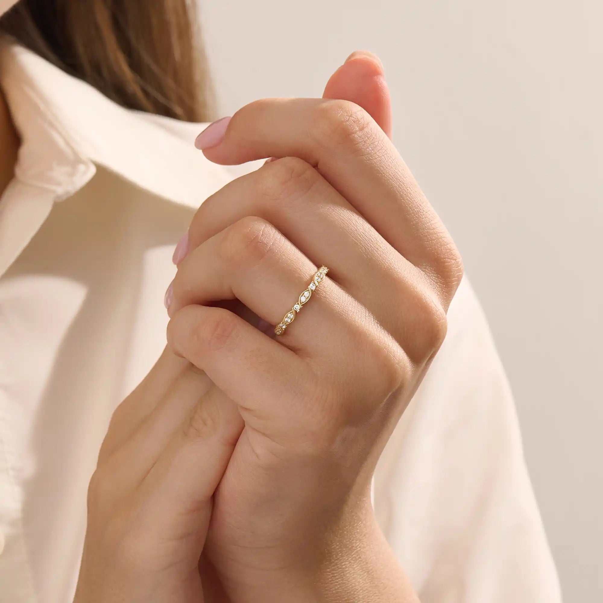 Model wears a 14k solid gold Art Deco-style stacking wedding ring featuring pave moissanites. Stylish and timeless design for modern brides.