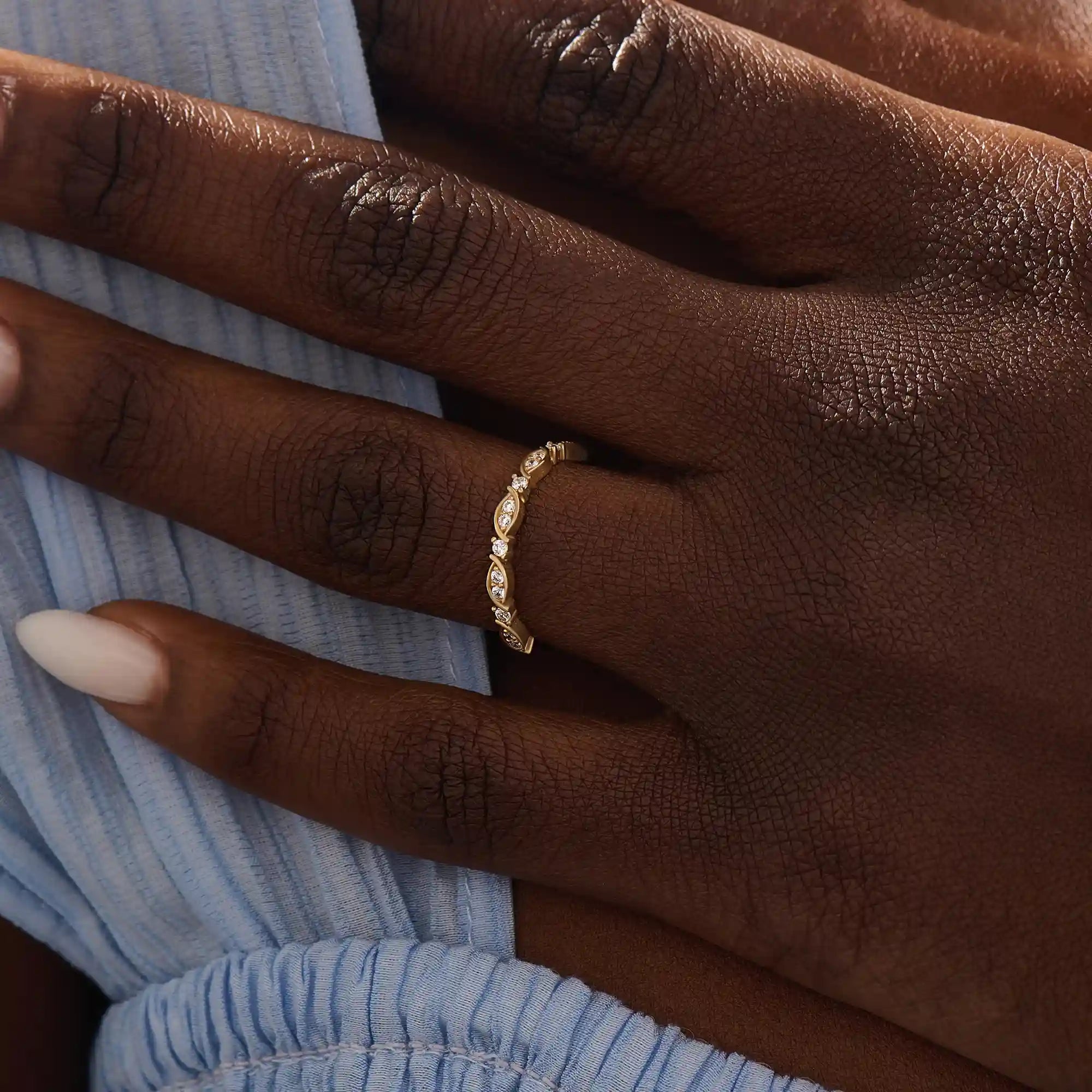 Model wears a 14k solid gold Art Deco-style stacking wedding ring featuring pave moissanites. Stylish and timeless design for modern brides.