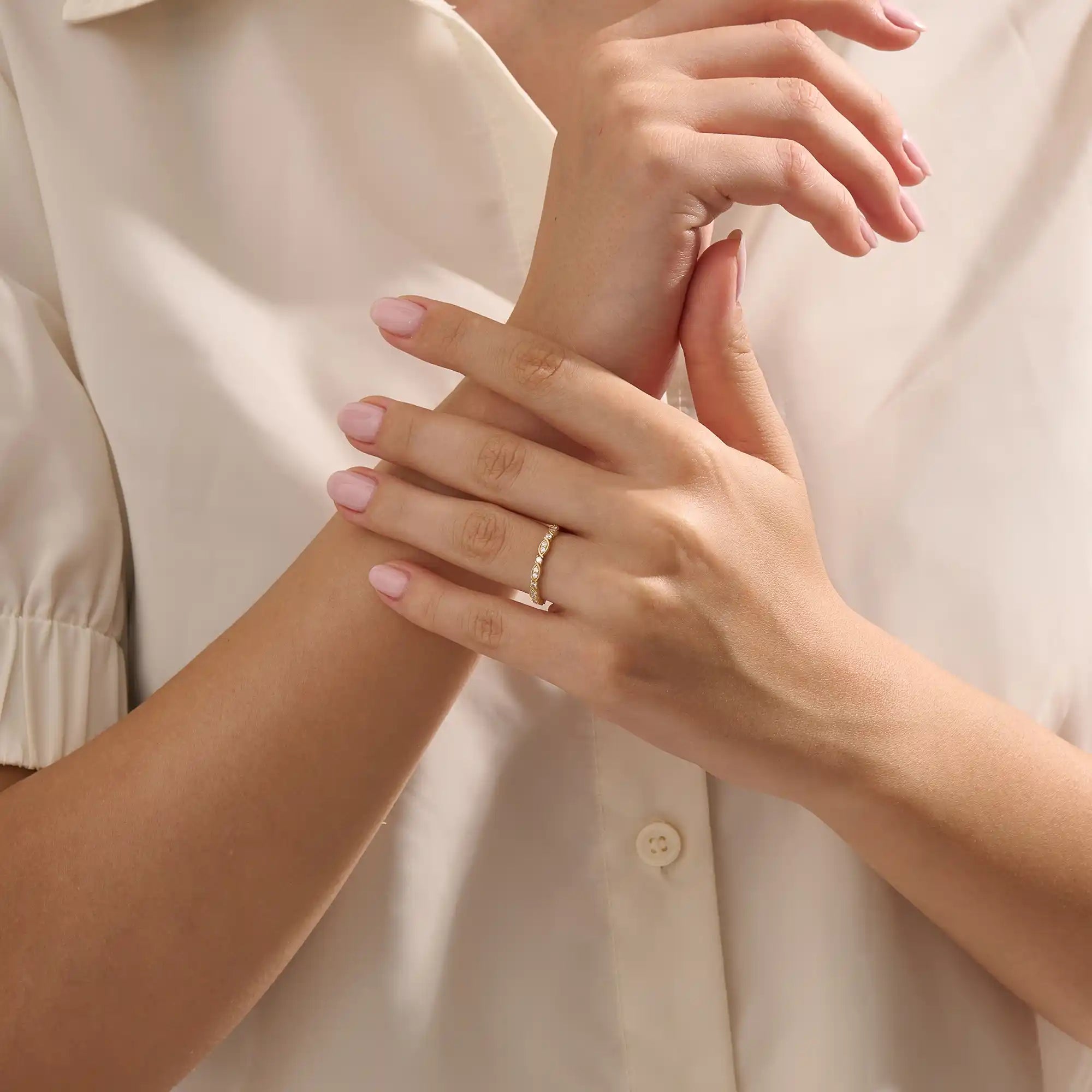 Model wears a 14k solid gold Art Deco-style stacking wedding ring featuring pave moissanites. Stylish and timeless design for modern brides.