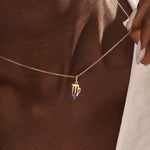Model wears a 14k solid gold Virgo zodiac pendant necklace with sapphire, perfect Virgo zodiac birthday jewelry gift.