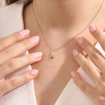 Model wears a 14k solid gold Virgo zodiac pendant necklace with sapphire, perfect Virgo zodiac birthday jewelry gift.