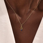 Model wears a 14k solid gold Virgo zodiac pendant necklace with sapphire, perfect Virgo zodiac birthday jewelry gift.