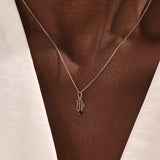 Model wears a 14k solid gold Virgo zodiac pendant necklace with sapphire, perfect Virgo zodiac birthday jewelry gift.