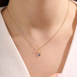 Model wears a 14k solid gold Virgo zodiac pendant necklace with sapphire, perfect Virgo zodiac birthday jewelry gift.