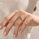 Model wears a 14k solid gold chunky ring featuring a natural moss agate gemstone. Bold and organic anniversary style.