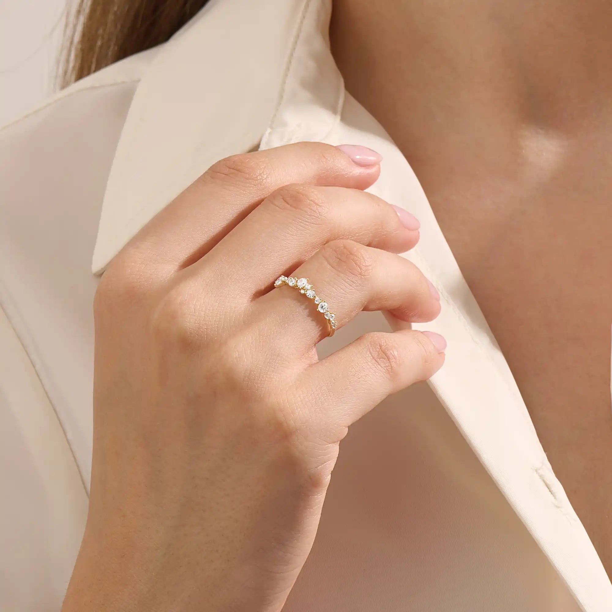 Model wears a 14k solid gold curved stackable wedding ring featuring cluster-pave moissanites. Elegant and versatile piece for layering or bridal wear.