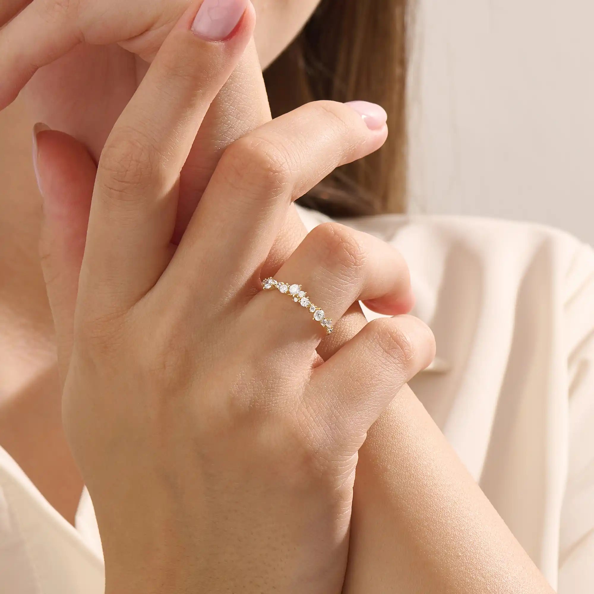 Model wears a 14k solid gold curved stackable wedding ring featuring cluster-pave moissanites. Elegant and versatile piece for layering or bridal wear.