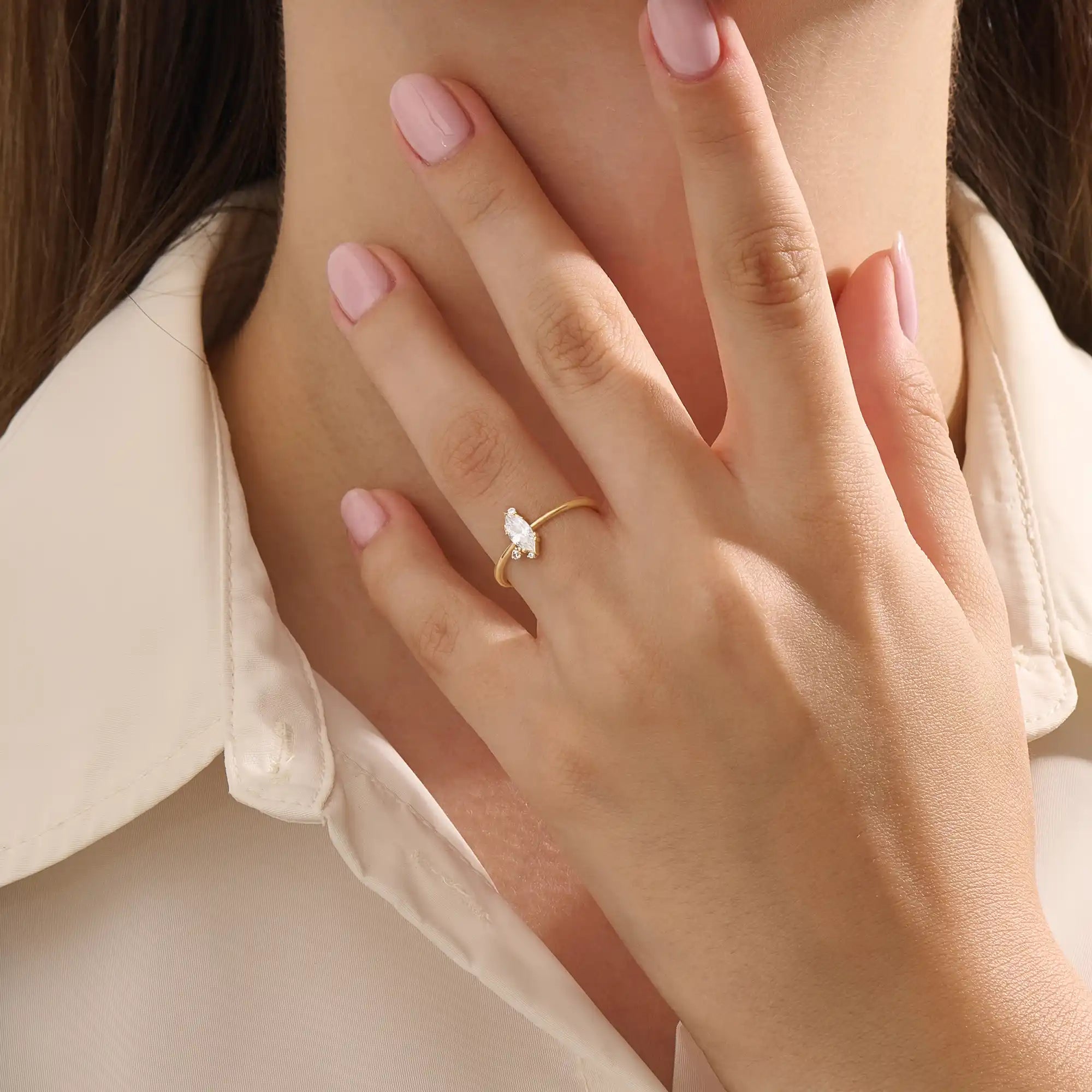 Model wears a 14k solid gold solitaire engagement ring with a marquise-cut moissanite. Minimalist and refined style, perfect for everyday bridal wear.