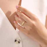 Model wears a dainty 14k gold daisy band with sparkling moissanites. A feminine statement ring with a bold yet romantic look.