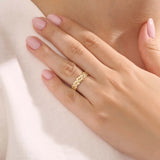 Model wears a dainty 14k gold daisy band with sparkling moissanites. A feminine statement ring with a bold yet romantic look.