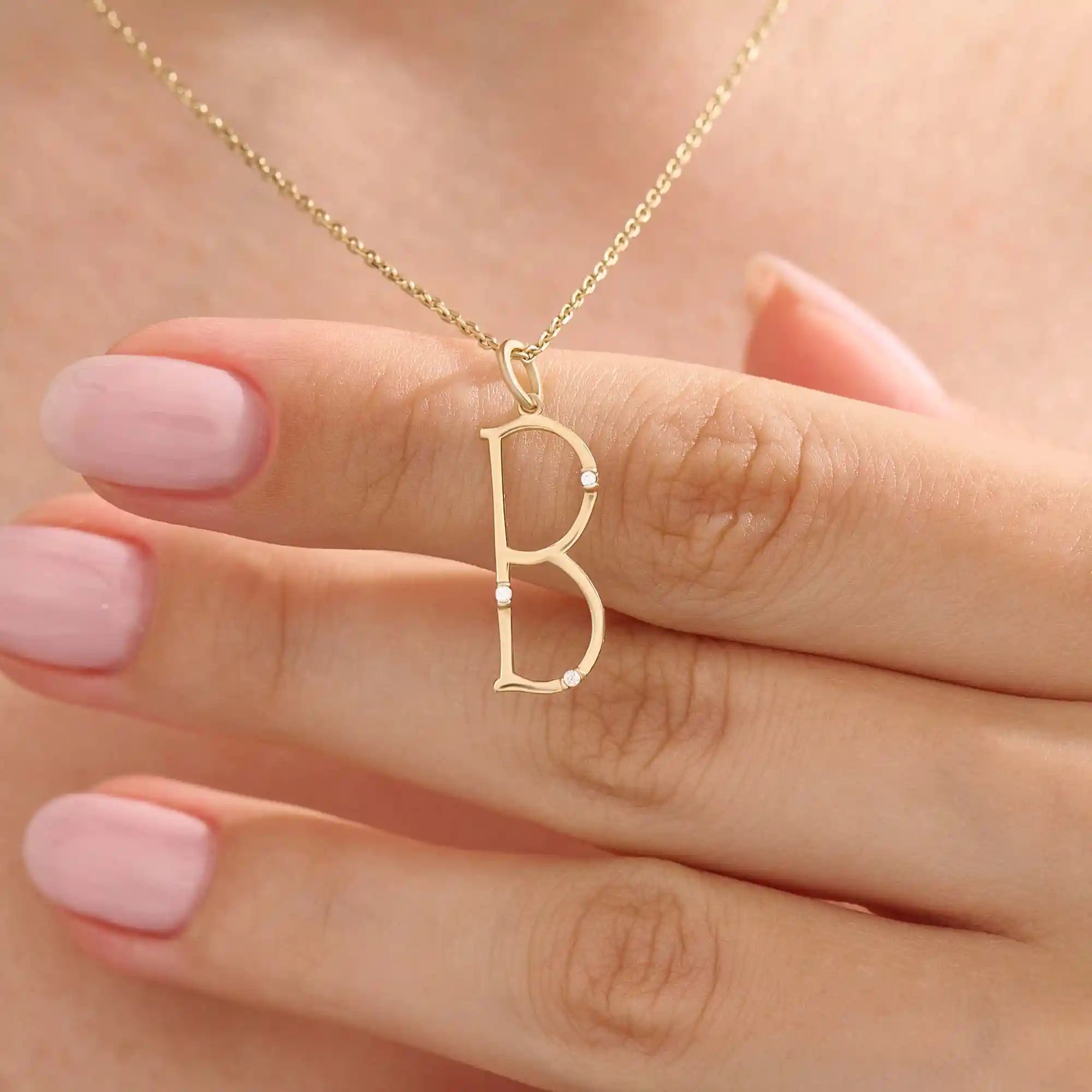 Model wears a slim 14k gold initial necklace featuring dainty moissanites. Elegant and minimal, perfect for layering or gifting.