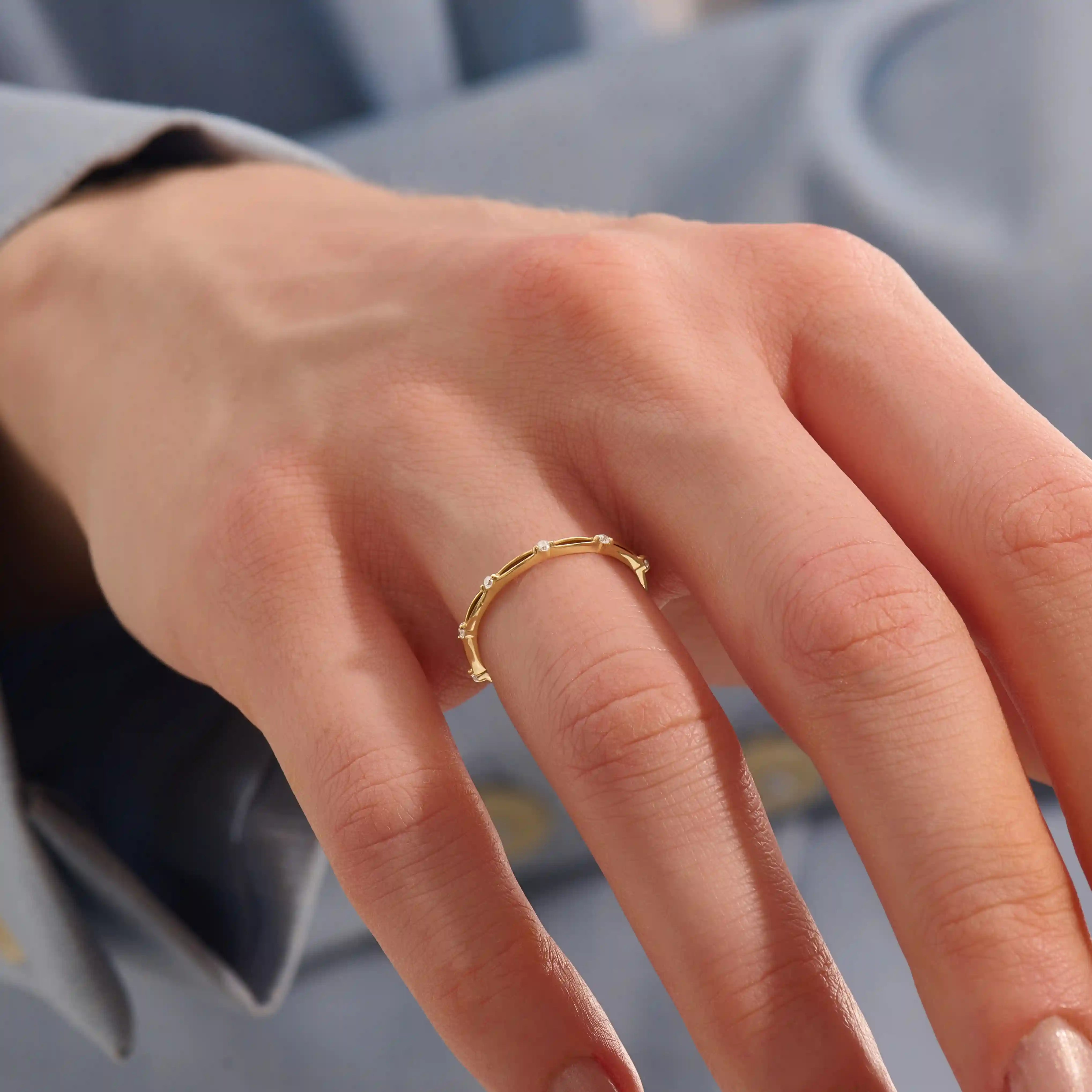 Model wears a slim 14k gold stacking ring with a clean minimalist style. Ideal for everyday wear and mixing with other rings.