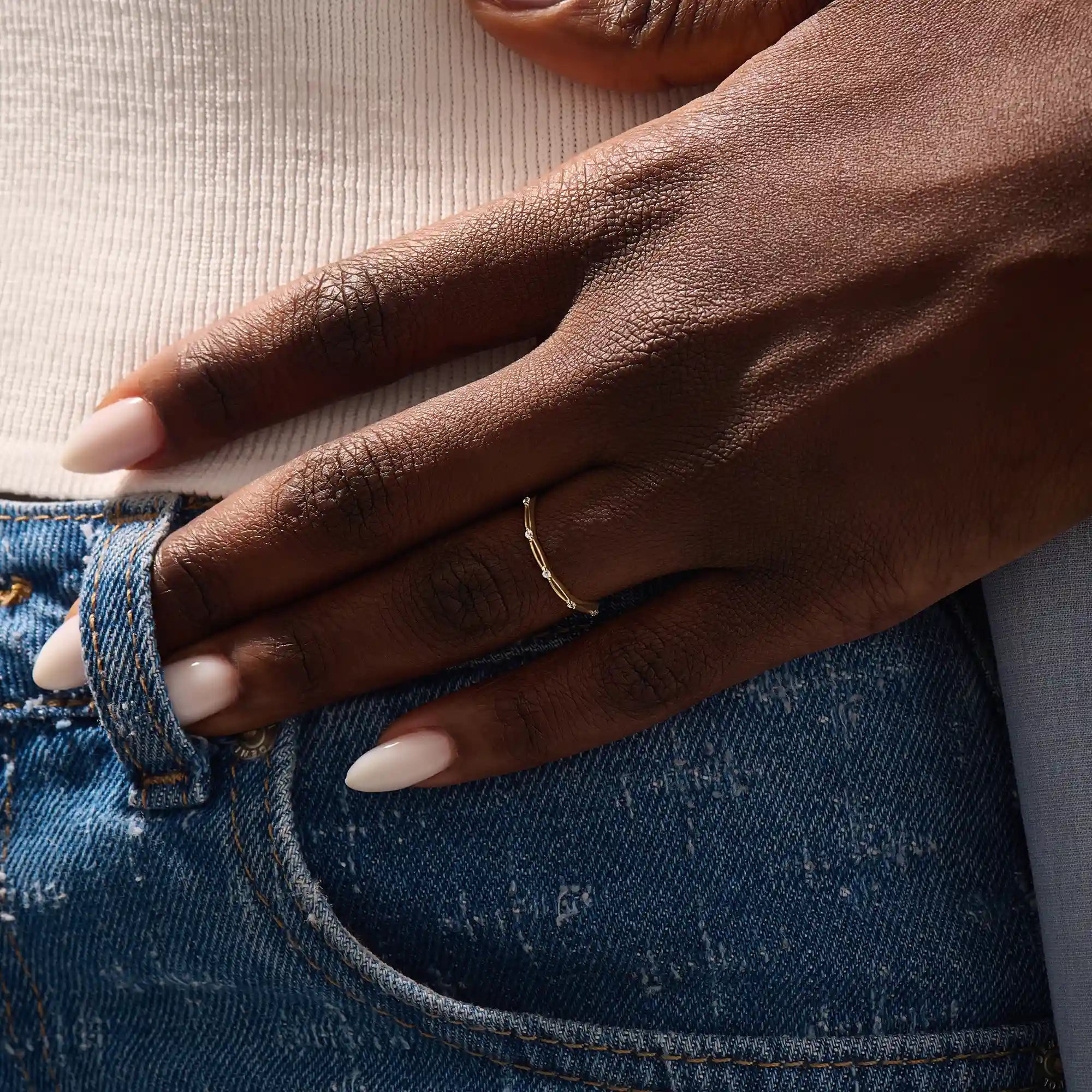 Model wears a slim 14k gold stacking ring with a clean minimalist style. Ideal for everyday wear and mixing with other rings.