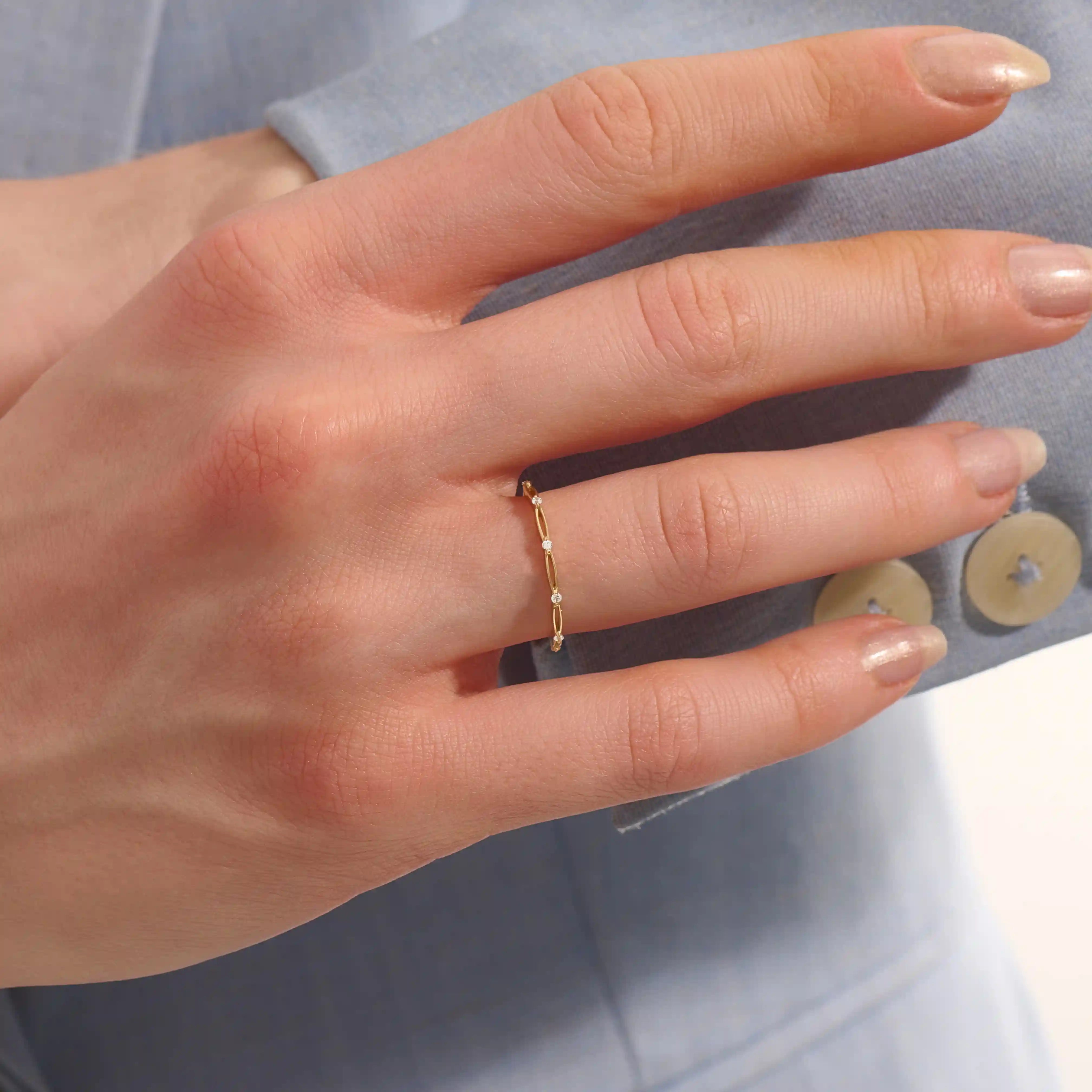 Model wears a slim 14k gold stacking ring with a clean minimalist style. Ideal for everyday wear and mixing with other rings.