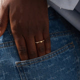 Model wears a uniquely designed 14k gold stacking ring. Adds elegant texture and style to layered ring looks.