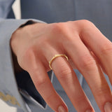 Model wears a uniquely designed 14k gold stacking ring. Adds elegant texture and style to layered ring looks.